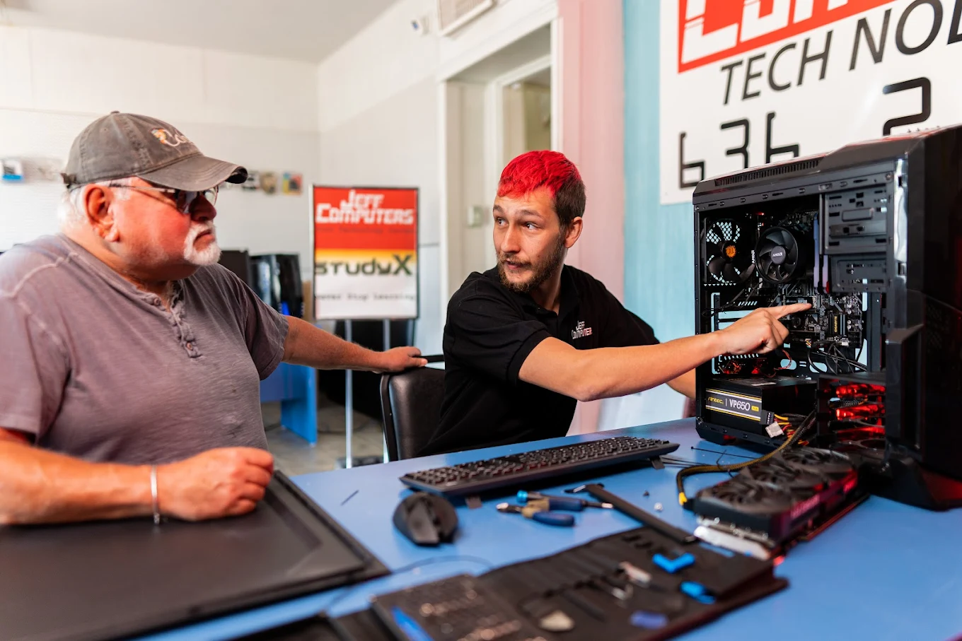 Man explaining computer components to customer